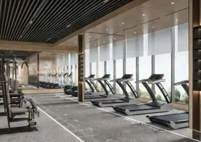 Fully equipped resident gym with treadmills and floor-to-ceiling windows at Riverside Azure Apartments on Riverside Drive