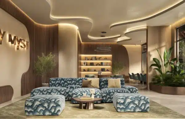 Modern premium co-working lounge with stylish blue patterned sofas, ambient ceiling lighting, and wooden slat acoustic wall panels at Ivy Mist Apartments in Kileleshwa, Nairobi.