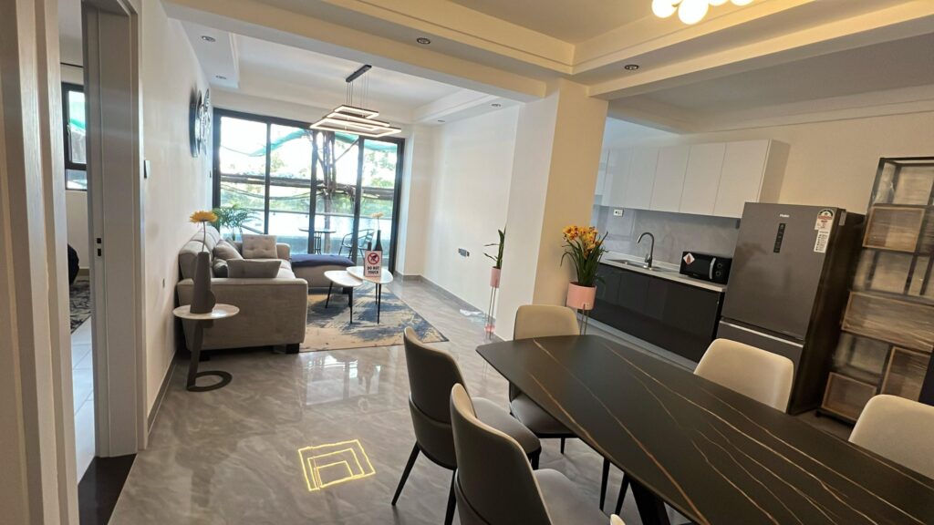 Interior architectural perspective of the combined living room, dining space, and kitchen at Serenity Residence in Kilimani, Nairobi.