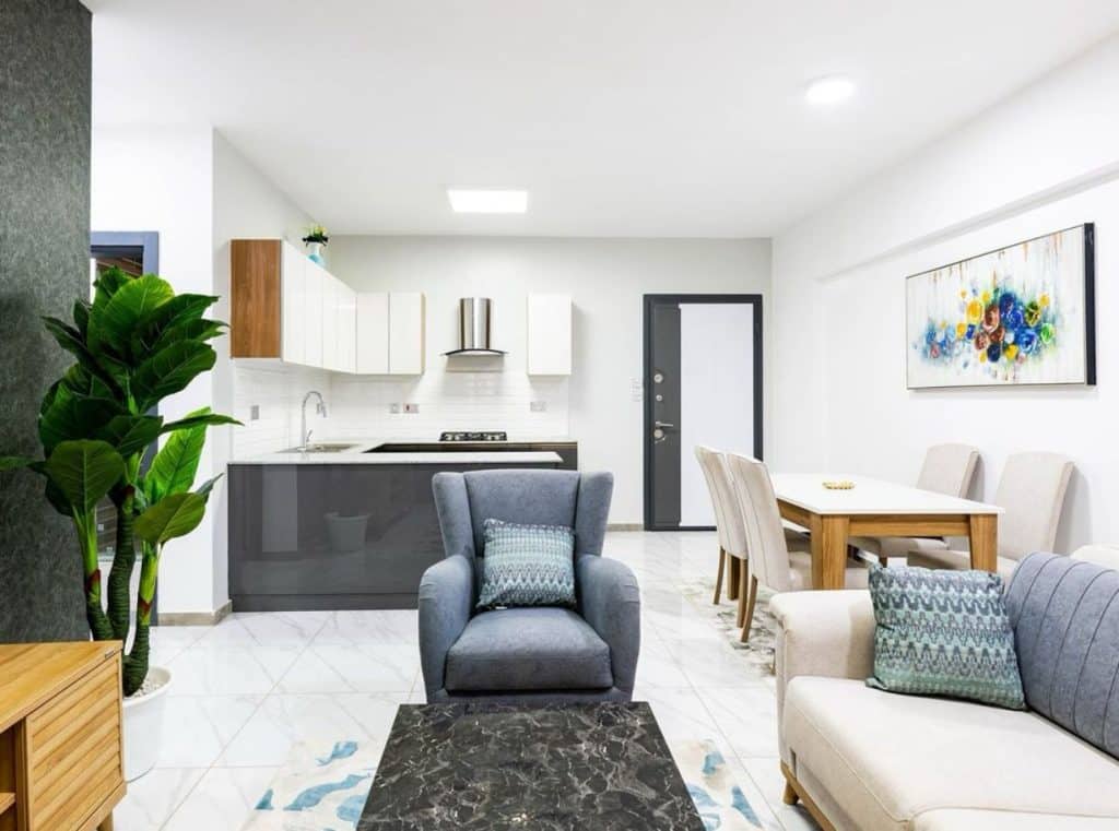Open plan living and dining room with tiled floors and fitted open kitchen at Ambra Heights Kileleshwa