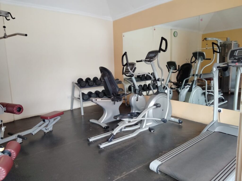 Resident fitness gym with treadmills, ellipticals, and dumbbells at Capital Apartments Valley Arcade