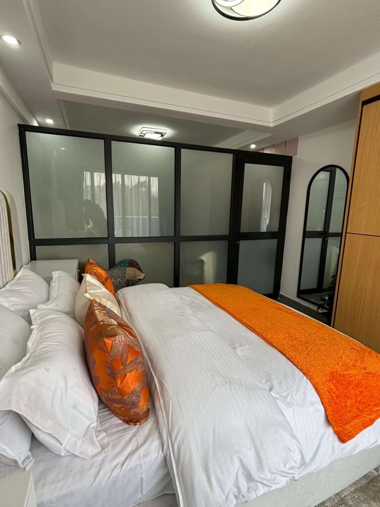 Furnished 1 bedroom layout with frosted glass privacy partition and double bed at Gatundu Heights Kileleshwa