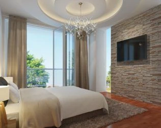 Master bedroom with wooden floor, chandelier, and walk-in closet entrance at Gitanga Duplexes Lavington