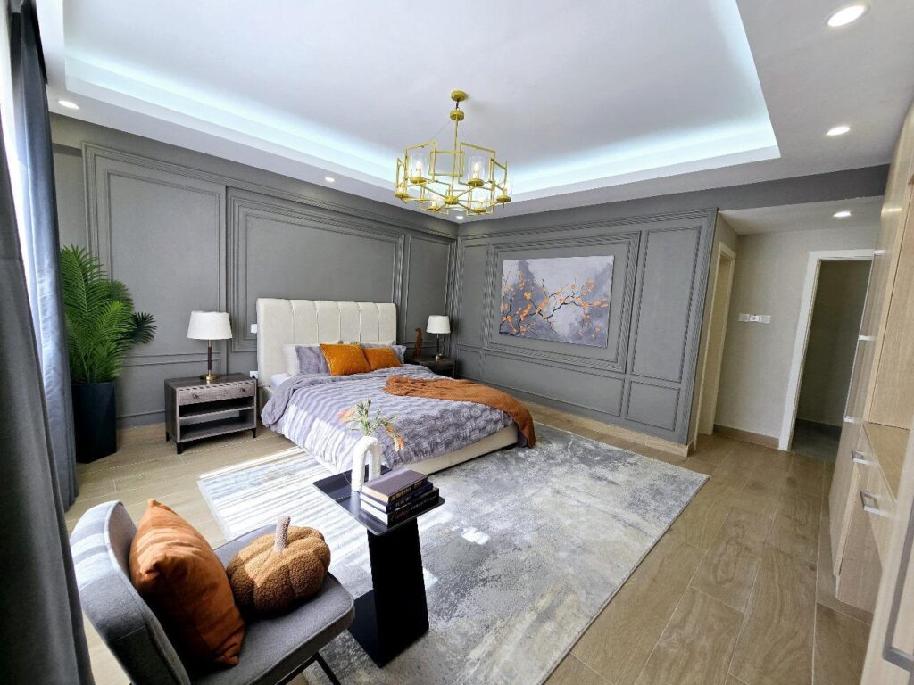 En-suite master bedroom with wall paneling and tray lighting at Golden Century Apartments Kileleshwa