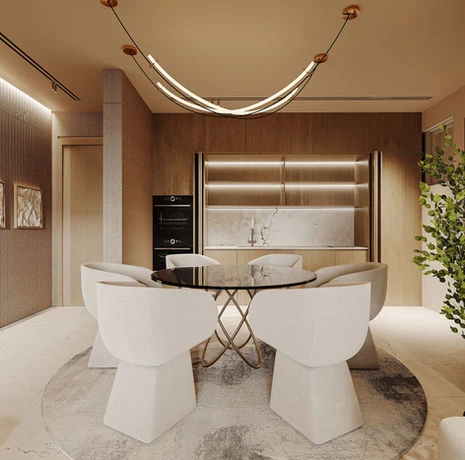Open-plan dining area with round glass dining table and fitted kitchen nook at Lumen by Wafi Parklands