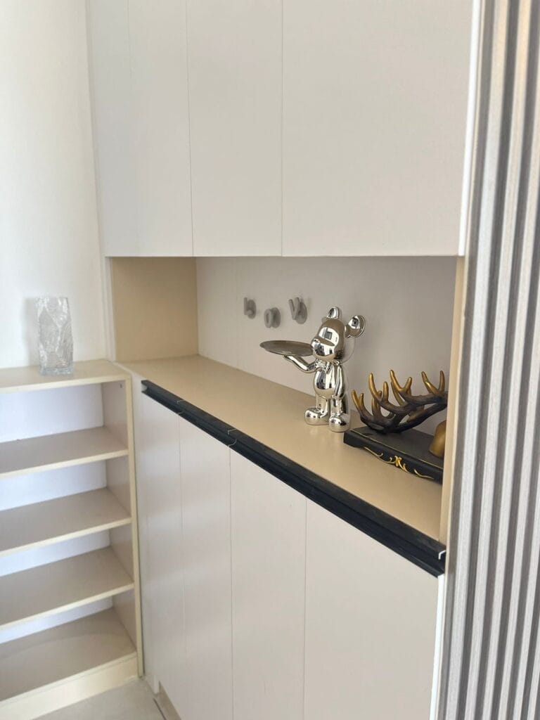 Built-in entry foyer storage cabinetry and display shelving at New Rise Gardens in Syokimau, Nairobi.