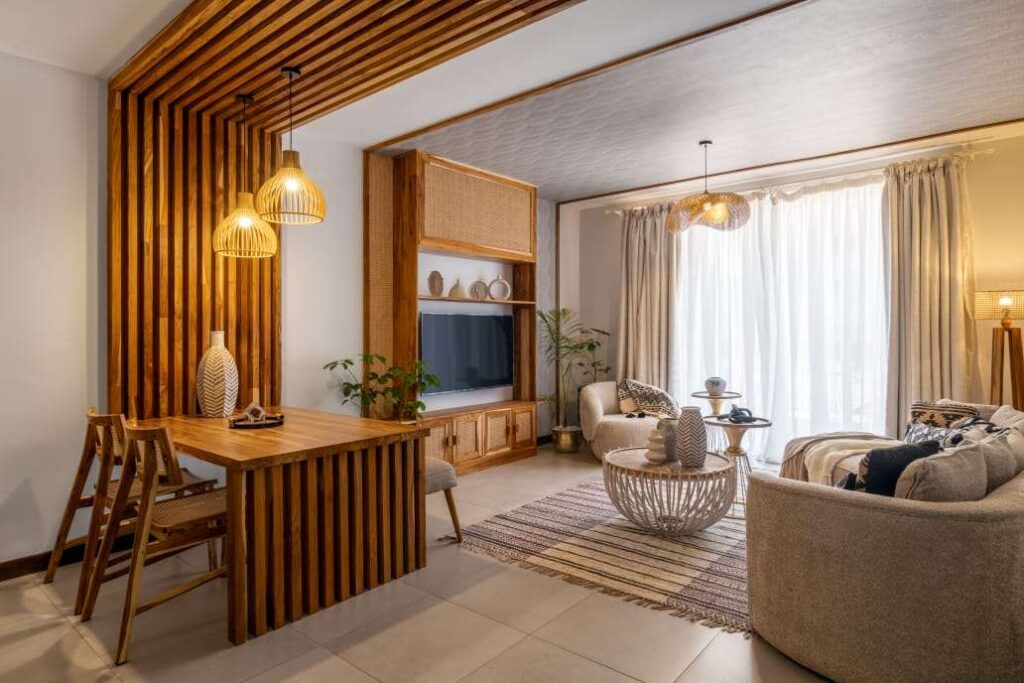 Open-plan living and dining space featuring custom wooden fluted room accents, built-in media console, and ample natural lighting at Sunpark Residences in Syokimau, Nairobi.
