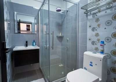 Modern bathroom with glass shower cubicle and vanity sink at Valley Heights Apartments Lavington