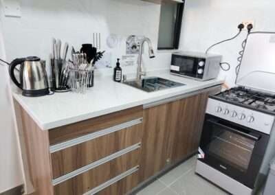 Kitchen counter with sink, microwave, and cooktop stove at Valley Heights Apartments Lavington