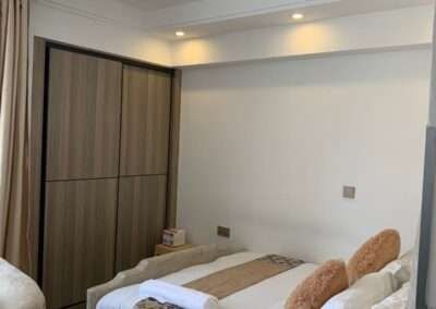 Bedroom with fitted wooden sliding wardrobes at Valley Heights Apartments Lavington