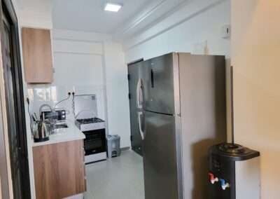 Fitted kitchen with gas stove top and stainless steel refrigerator at Valley Heights Apartments Lavington