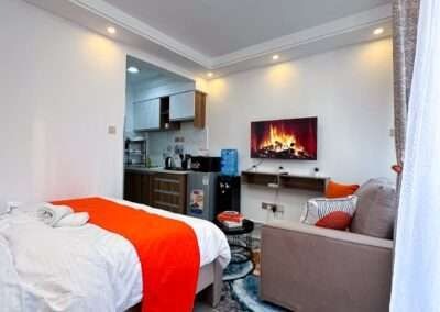 Furnished studio apartment bedroom and kitchenette area at Valley Heights Apartments Lavington